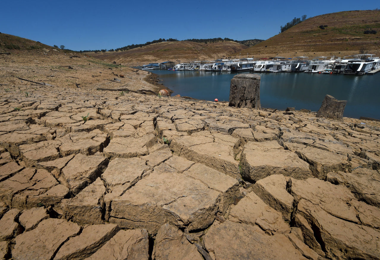 Dried mud and the remnants of a marina is seen at the New Melones Lake reservoir which is now at less than 20 percent capacity as a severe drought continues to affect California on May 24, 2015.  California has recently announced sweeping statewide water restrictions for the first time in history in order to combat the region's devastating drought, the worst since records began.          AFP PHOTO/ MARK RALSTON        (Photo credit should read MARK RALSTON/AFP/Getty Images)