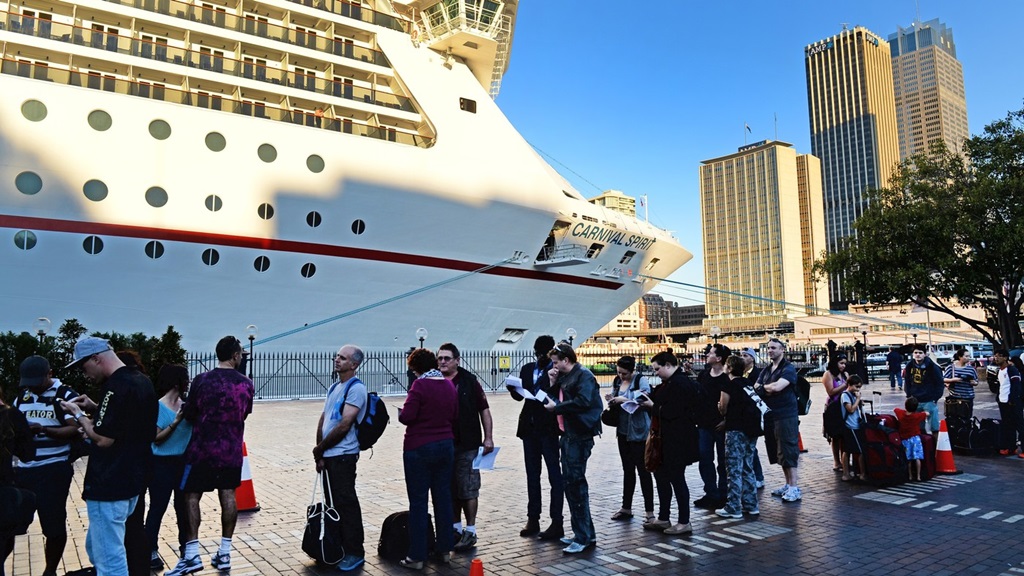 Passengers queue at Sydney's Circular Quay to board the Carnival Spirit for a Pacific cruise, on Thursday.
